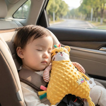 bébé endormi dans la voiture la tête sur doudou tigre